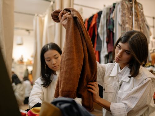 Woman inspecting a top at the thirft store