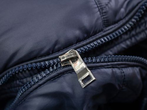 a coat with ruined zippers
