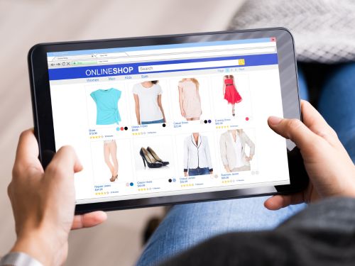 person thrift shopping on a laptop