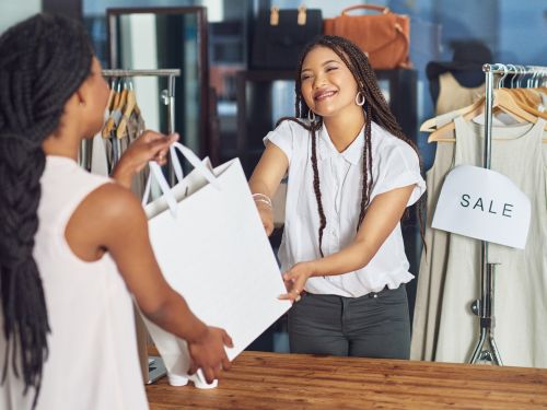 woman hanging a bag to a customer